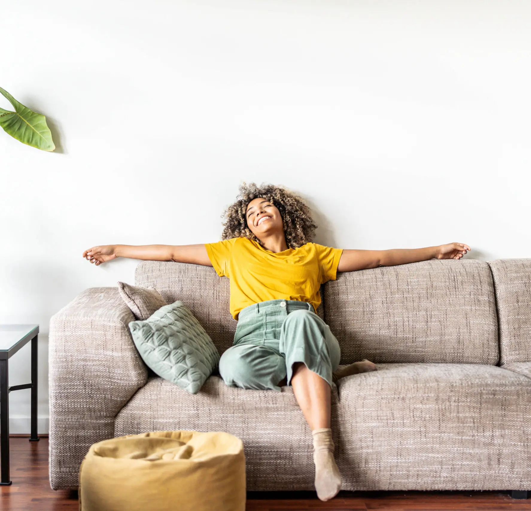 happy afro american woman relaxing on the sofa at home smiling